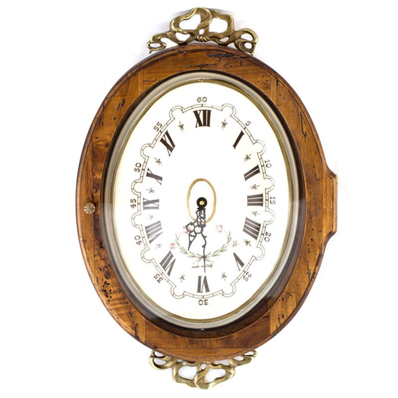 Часы старинные овальные с металлическим декором